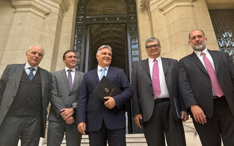 El gobernador y su equipo, sonrientes al salir de la audiencia.