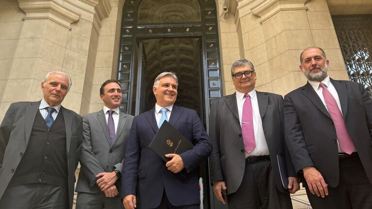 El gobernador y su equipo, sonrientes al salir de la audiencia.