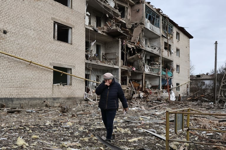 En esta imagen, distribuida por la oficina de prensa de la 65ta Brigada Mecanizada de Ucrania, una vecina pasa junto a un edificio destrozado por un ataque aéreo ruso en Komyshuvakha, en la región de Zaporiyia, Ucrania, el 20 de febrero de 2026. (Andriy Andriyenko/65ta Brigada Mecanizada de Ucrania vía AP)