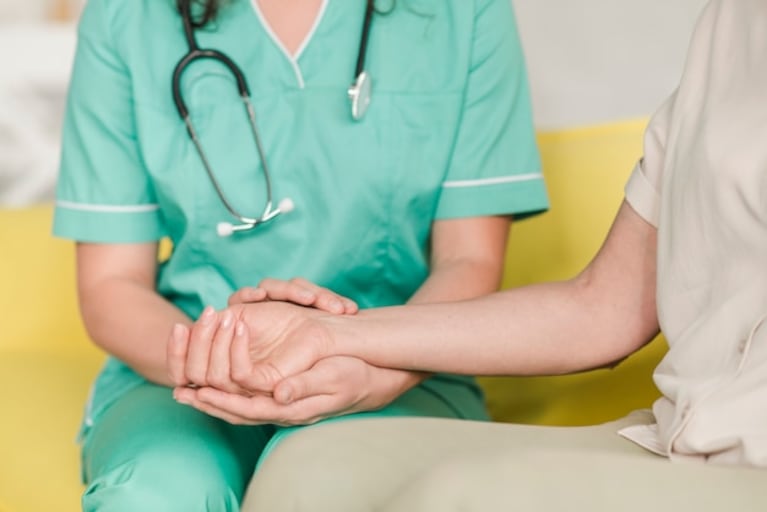 Enfermera que controla pulso en la muñeca del paciente femenino Foto gratis