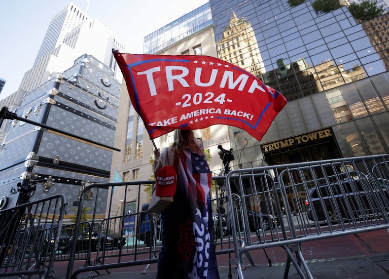 FILE PHOTO: A person waves a Trump flag outside Trump Tower, after U.S. President-elect Donald Trump won the presidential election, in New York City, U.S., November 6, 2024.  REUTERS/Kent J. Edwards/File Photo