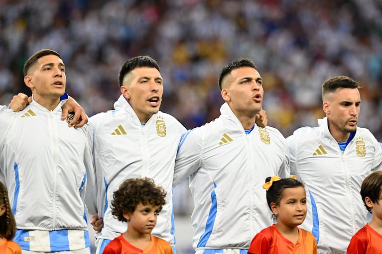 Jul 4, 2024; Houston, TX, USA; Argentina's full-back Nahuel Molina (26), defender Lisandro Martinez (25), striker Lautaro Martinez (22) and defender Nicolas Tagliafico (3) sing during Argentina National Anthem at a Copa America quarterfinal soccer match against Ecuador at NRG Stadium. Mandatory Credit: Maria Lysaker-USA TODAY Sports