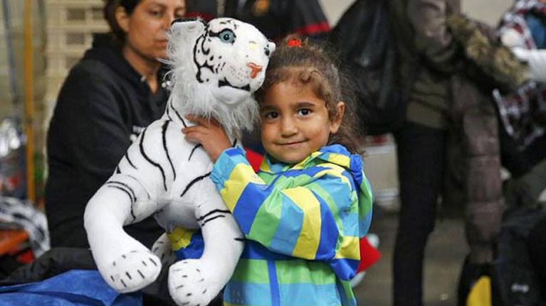Los chicos juegan con los peluches que le regalan los ciudadanos alemanes. Foto: Reuters