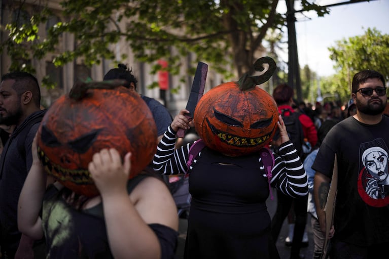 People wearing pumpkin masks attend the Zombie Walk, in Santiago, Chile, October 20, 2024. REUTERS/Pablo Sanhueza