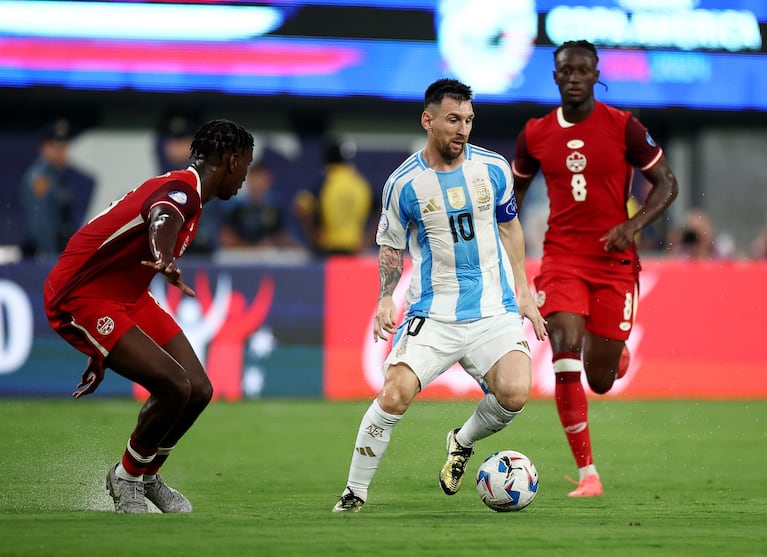 Soccer Football - Copa America 2024 - Semi Final - Argentina v Canada - MetLife Stadium, East Rutherford, New Jersey, United States - July 9, 2024 Argentina's Lionel Messi in action with Canada's Moise Bombito REUTERS/Agustin Marcarian